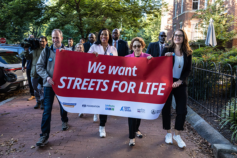 From left: NHTSA’s Adam Raviv, Mayor Muriel Bowser, USDOT’s Secretary Polly Trottenberg, and FHWA’s Kristin White walk to school with students.